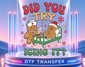 May include: A DTF transfer sheet featuring a cartoon graphic of a gingerbread nurse holding a bottle next to a sick gingerbread person in a hospital bed. The text reads DID YOU TRY ICING IT? surrounded by red snowflakes and yellow stars.