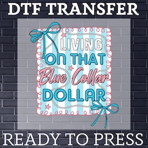 May include: DTF transfer design with the text "LIVING ON THAT Blue Collar DOLLAR" in a blue and pink color scheme. The design includes bows and stars, ready to press.