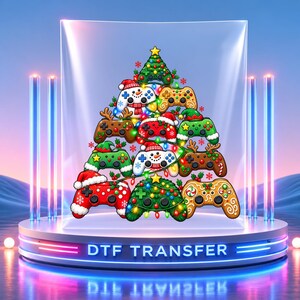 May include: A DTF transfer featuring a Christmas tree design composed of various video game controllers. The controllers are decorated with holiday themes including snowmen, reindeer antlers, Santa hats, and colorful string lights.