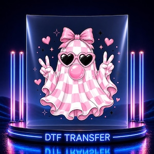 May include: A DTF transfer featuring a ghost character with a pink and white checkered pattern, wearing heart-shaped sunglasses and a large pink bow on its head. The ghost is blowing a pink bubble and making peace signs with both hands, surrounded by small pink hearts and star icons.