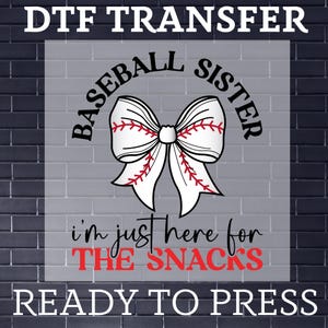 May include: A white and red baseball-themed bow with the text "Baseball Sister" above and "I'm just here for the snacks" below. The image is labelled "DTF Transfer Ready to Press".