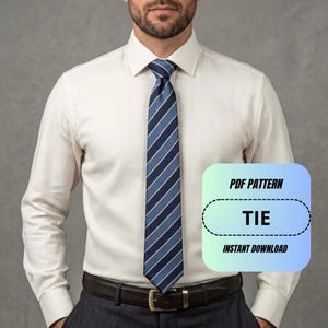 May include: A long-sleeve off-white button-down shirt paired with a blue, navy, and white diagonal striped necktie and a dark brown leather belt. A digital overlay box displays the text PDF PATTERN TIE INSTANT DOWNLOAD.
