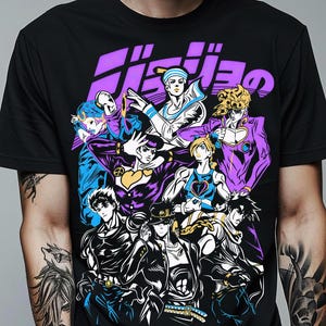May include: Black t-shirt featuring a group of anime characters in various poses. The graphic includes characters in purple, blue, yellow, and white, with Japanese text at the top. The design is a vibrant illustration.