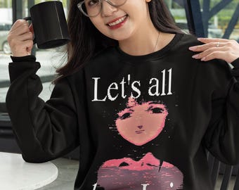 May include: Black sweatshirt with the text "Let's all love Lain" and a graphic of a person's face in pink and white. The person in the image is holding a black mug.