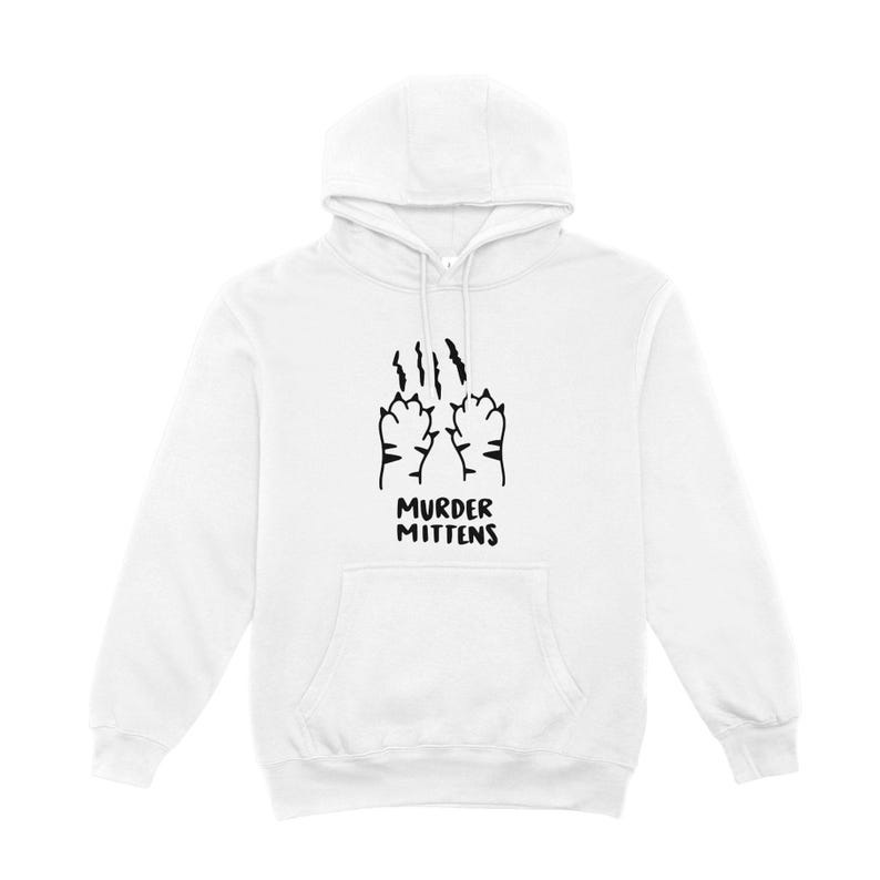 May include: White hooded sweatshirt with a front pocket and drawstring. The front features a black graphic of cat paws with claw marks and the text "MURDER MITTENS" in a playful font.