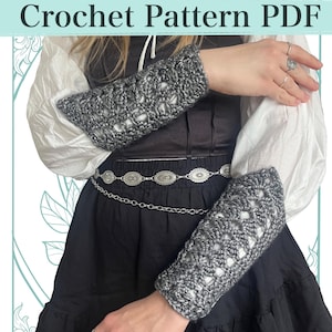 May include: A pair of dark gray crochet arm warmers featuring an openwork stitch pattern. The text "Crochet Pattern PDF" is displayed in a horizontal banner across the top of the image. The arm warmers are worn over a white long-sleeved shirt.