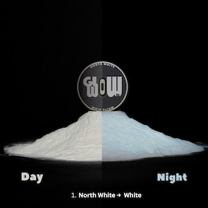 May include: A product demonstration image showing a pile of white powder that glows blue at night. The product is labeled "North White" and "That Glow". The text "Day" and "Night" are also visible.