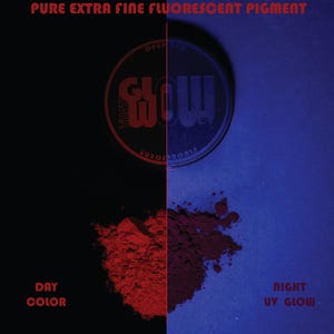May include: Image of a split screen showcasing fluorescent pigment. The left side displays the day color, a vibrant red powder. The right side shows the night UV glow, a deep blue hue. The product container is visible.