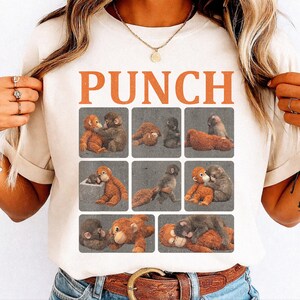 Puede incluir: Camiseta color crema con la palabra "PUNCH" en letras naranja. Debajo, una cuadrícula de ilustraciones de monos de estilo vintage en marrón y beige sobre un fondo gris. Los monos se muestran en diferentes poses.