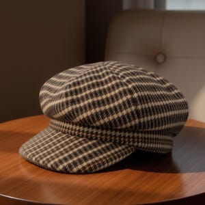 May include: A brown and beige checked newsboy cap with a flat brim.
