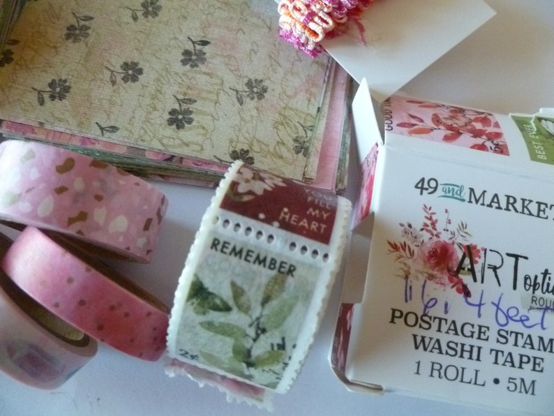 May include: A roll of floral patterned washi tape with the text "Art Options" and "11/16" 4 feet Postage Stamp Washi Tape 1 Roll 5M" on the packaging.