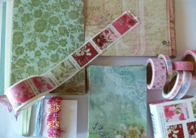 May include: A collection of decorative washi tapes with floral patterns and the words "You fill my heart", "Remembrance", "Forever", and "Always" printed on them. The tapes are arranged on a background of patterned paper.