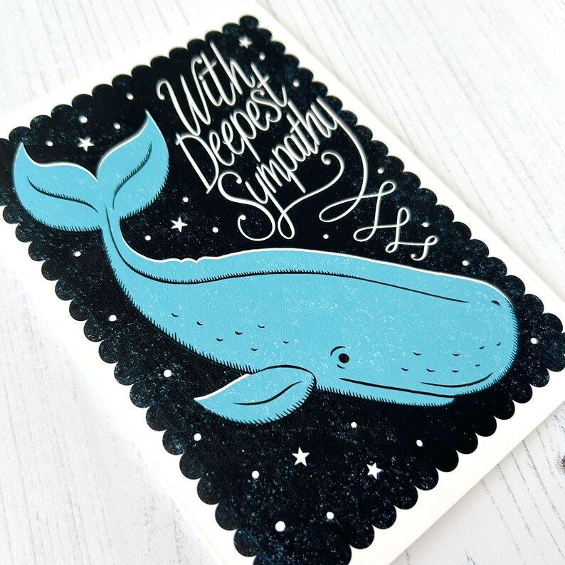 May include: A sympathy card with a blue whale illustration on a black background with stars. The card has a scalloped edge and the words "With Deepest Sympathy" in white script.