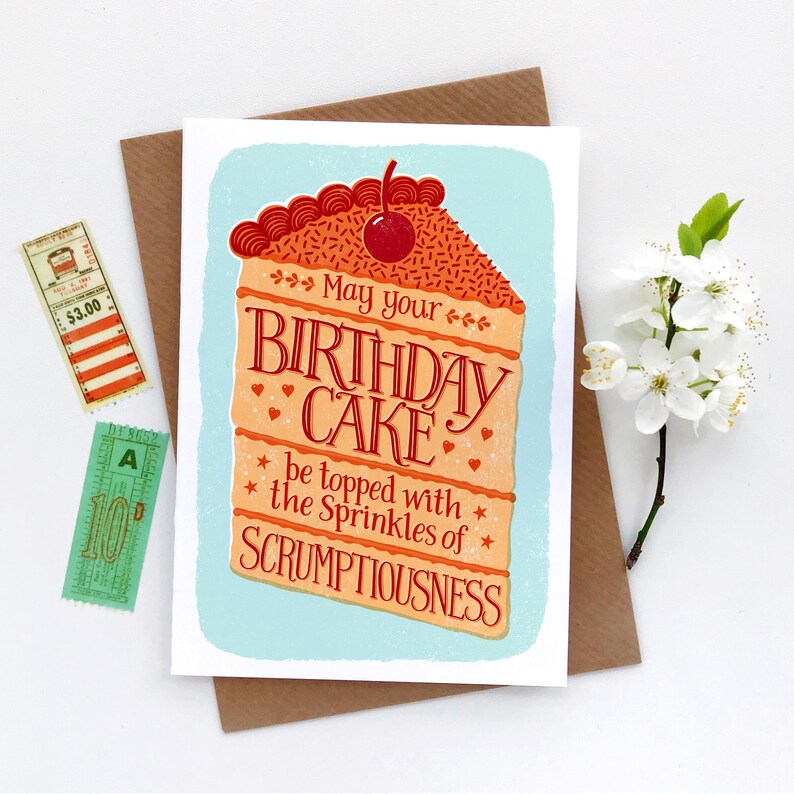 May include: A birthday card with a colorful illustration of a slice of cake with a cherry on top. The text on the card reads "May your birthday cake be topped with the sprinkles of scrumptiousness."