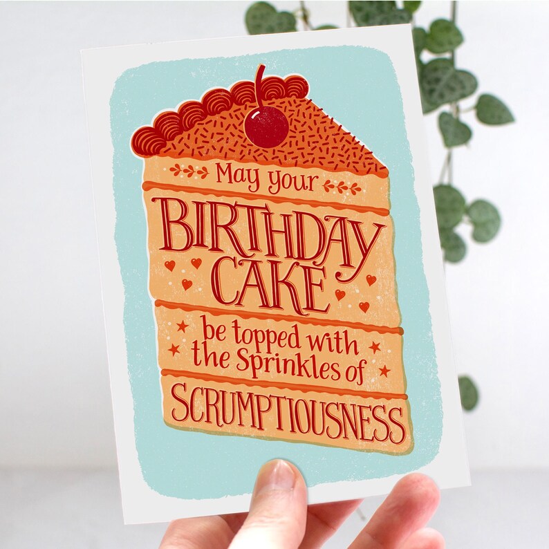 May include: A birthday card with a colorful illustration of a slice of cake with a cherry on top. The text reads "May your birthday cake be topped with the sprinkles of scrumptiousness."