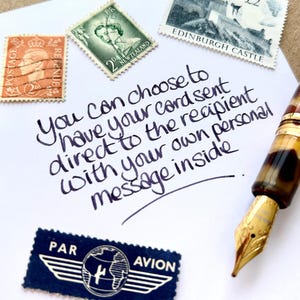 May include: A handwritten note on white paper with the text "You can choose to have your card sent direct to the recipient with your own personal message inside."  The note is surrounded by vintage postage stamps.
