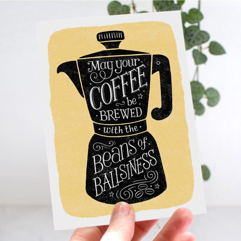 May include: A yellow and black illustration of a coffee pot with the text "May your coffee be brewed with the beans of ballisness".