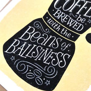May include: Black and white illustration of a coffee pot with the text "be. coffee. brewed with the beans of ballsiness".
