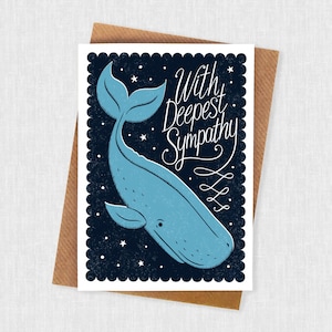 May include: A sympathy card with a blue whale illustration on a dark blue background with white stars. The card reads "With Deepest Sympathy" in elegant script. The card is set on a brown envelope.