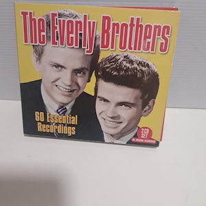 May include: A CD set of The Everly Brothers, with a yellow and red cover. The cover features two black and white portraits of the singers and the text "The Everly Brothers" and "60 Essential Recordings".