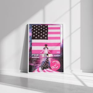 May include: Framed poster featuring a pink and black American flag design. The poster includes the text "PINK TAPE" and a tracklist. A pink circle with text and a QR code is also visible. The poster is displayed in a white frame.