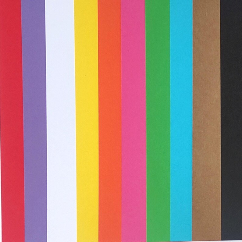 May include: A collection of 10 different colored cardstock paper strips. The colors are red, purple, white, yellow, orange, pink, green, blue, brown, and black.