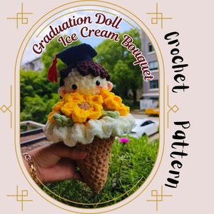 May include: A handmade crochet ice cream cone bouquet featuring a graduation doll. The doll wears a graduation cap with a red tassel and is surrounded by yellow flower accents. The cone is brown, and the bouquet is held in a hand.