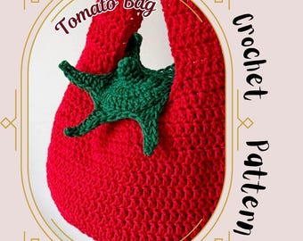 May include: A handmade red crochet bag shaped like a tomato, with a green crocheted leaf detail. The bag has the words "Tomato Bag" in a cursive font. The words "Crochet Pattern" are also visible. The bag is a unique, handcrafted item.