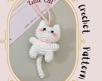 Peut inclure: Un chat blanc au crochet avec des joues roses et des yeux noirs, portant une écharpe rose. Le chat est suspendu par une ficelle rose. L'image comprend le texte "Little Cat" et "Crochet Pattern".