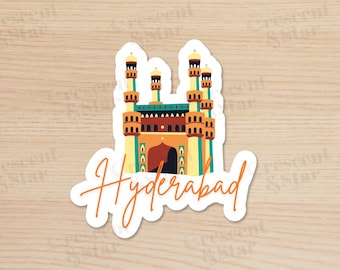 May include: A white sticker with a colorful illustration of a building with multiple towers and arches. The text "Hyderabad" is written in a cursive font below the building.