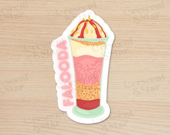 May include: A sticker of a glass of falooda, a popular Indian dessert. The falooda is layered with rose syrup, vermicelli, and ice cream, topped with a red syrup and chopped nuts. The sticker is pink and green and has the word "Falooda" written on it.