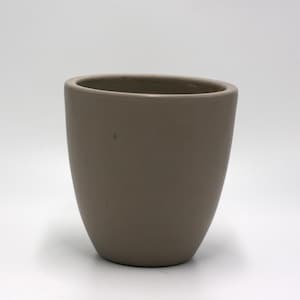 May include: A light gray ceramic planter with a rounded, oval shape. The planter is smooth and has a matte finish.