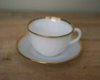 vintage fire king cup and saucer white with gold trim