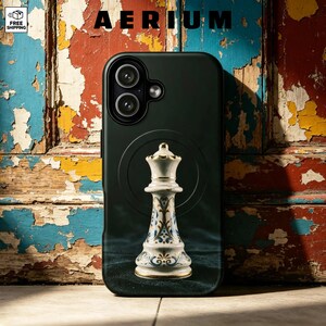 May include: A black smartphone case featuring a centered graphic of a white chess queen piece with intricate blue and gold filigree patterns. The case has a dual-lens camera cutout at the top left and a circular magnetic ring design on the back.