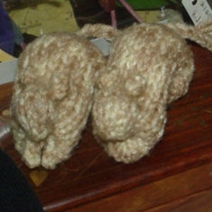 May include: Two knitted brown and white mouse toys with long tails.