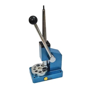 May include: A blue ring sizing tool with a black handle and a silver ring sizer. The tool has a round base with multiple holes and a silver lever. The tool is designed for jewelry making.