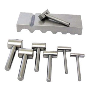 May include: A set of silver metal hammers of varying sizes, with a matching metal block. The hammers have cylindrical heads and handles, and the block has a groove and several cutouts. The tools are arranged on a white background.