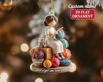 May include: A 2D flat ornament featuring a woman knitting, with a cat figurine and colorful yarn balls. The ornament has the text "Custom name" and "2D FLAT ORNAMENT". The base reads "Just a girl who loves knitting" and includes the name "Monica".