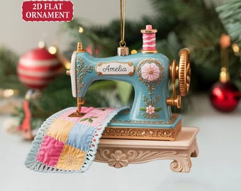 May include: A blue sewing machine ornament with gold accents and the name "Amelia". The ornament features a pink spool of thread, a colorful quilt, and the text "Customized 2D Flat Ornament".