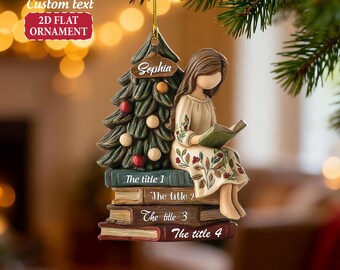 May include: A 2D flat ornament featuring a girl reading on a stack of books, with a Christmas tree. The ornament has the text "Custom text" and "2D FLAT ORNAMENT". The tree has ornaments and the name "Sophia". The books have titles.