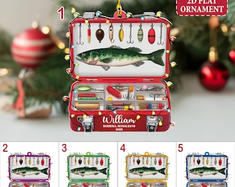 May include: A red, 2D flat ornament shaped like a tackle box, featuring a green fish and fishing lures. The ornament has the text "William" and "BERBERA, SOMALILAND 2025". The ornament is decorated with small lights.