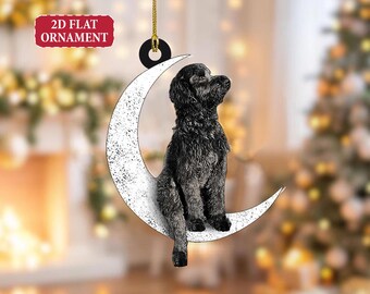 May include: A 2D flat ornament featuring a black dog sitting on a white crescent moon. The ornament has a gold string for hanging and the text "2D FLAT ORNAMENT" in a red rectangle.