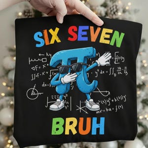May include: Black tote bag featuring a blue Pi symbol wearing sunglasses and doing a dab pose. The words "SIX SEVEN" and "BRUH" are in colorful letters. Mathematical equations are in the background.