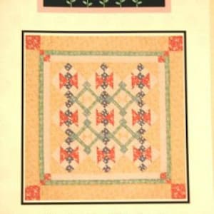 May include: Quilt pattern for a "Hickety Pickety" quilt, designed by Kari Ramsay. The pattern is for a quilt that is 50 inches by 30 inches or 61 inches by 72 inches. The quilt pattern features a geometric design with red, blue, and green squares.