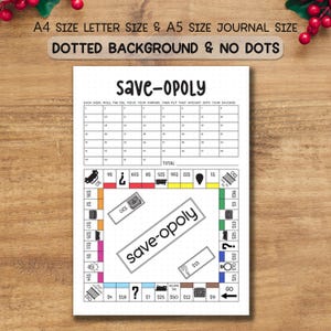 May include: A white paper with the text "save-opoly" in a handwritten font. The paper has a grid for tracking savings, and a game board design with dollar amounts and question marks. The text "A4 SIZE LETTER SIZE & A5 SIZE JOURNAL SIZE" is at the top.