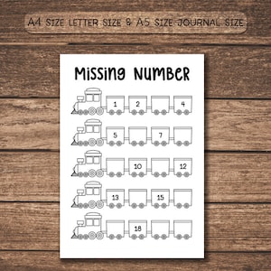 May include: Black and white worksheet with the title "Missing Number". The worksheet features train illustrations with numbered train cars, designed for educational activities. The text "A4 SIZE LETTER SIZE & A5 SIZE JOURNAL SIZE" is at the top.