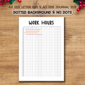 May include: A white paper with a work hours chart, featuring the text "WORK HOURS" at the top. The chart is divided into AM and PM sections, with numbered rows and columns. The paper is on a wooden surface.