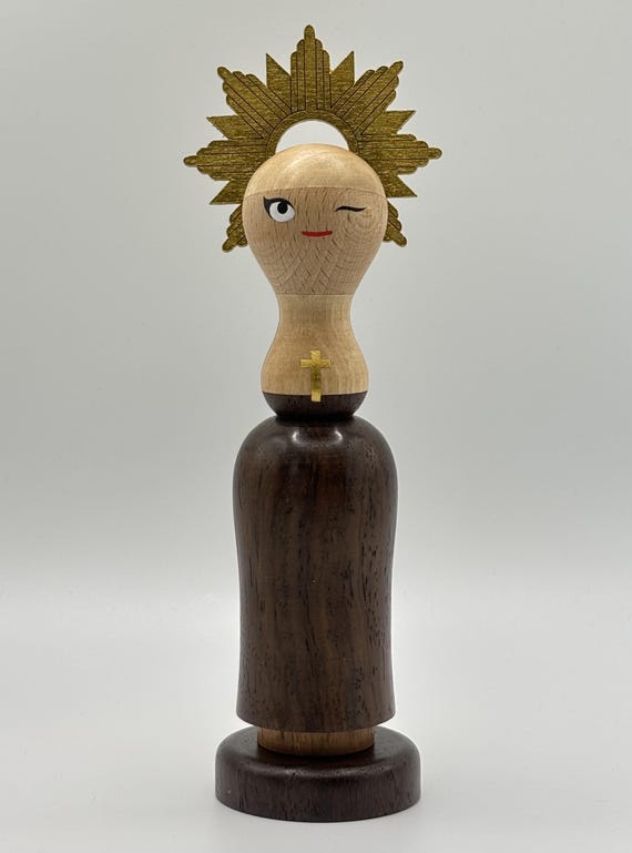 A lathe-turned wooden nun figurine that somehow straddles fine craft and irreverent humor — the kind of object that lives on a shelf and starts conversations for years.