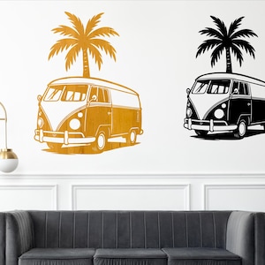 May include: Wall art featuring two stylized illustrations of a vintage van with a palm tree on top. One is gold, the other black. The van has a white front and a boxy shape, evoking a retro, beachy vibe. The art is mounted on a white wall.