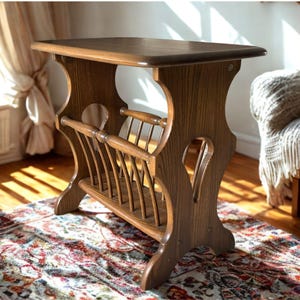 May include: A wooden side table with a magazine rack. The table has a rectangular top and curved legs. The magazine rack is made of wooden slats. The table is brown and sits on a patterned rug. The table is approximately 61 cm tall.